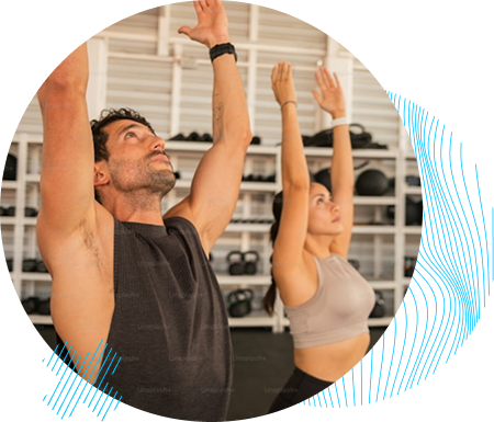 A male and female fitness participants performing a guided stretching exercise in a gym, focusing on mobility and flexibility at GrowthLab 360.
